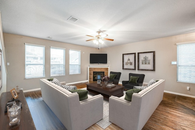 11019 Chestnut Path Way, Tomball, TX 77375 - living room featuring ceiling fan, baseboards, a fireplace, and healthy amount of natural light