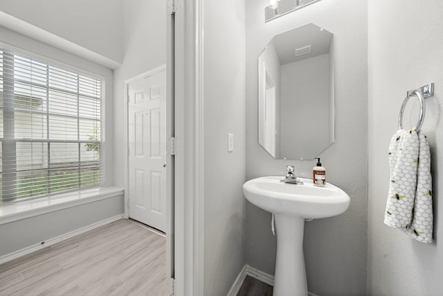 114 N Camellia Grove Cir, The Woodlands, TX 77382 - bathroom featuring healthy amount of natural light, baseboards, wood finished floors, and a sink