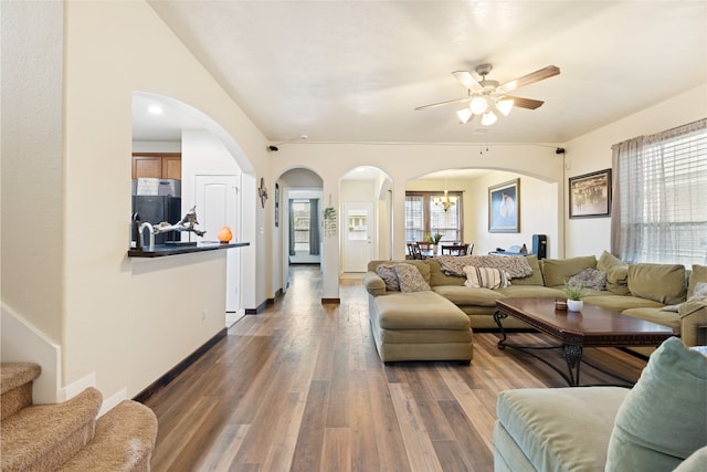 13610 Spectacled Bear Ln, Crosby, TX 77532 - living area with arched walkways, ceiling fan, wood finished floors, stairway, and lofted ceiling