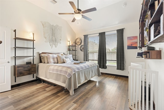 13610 Spectacled Bear Ln, Crosby, TX 77532 - bedroom with wood finished floors, lofted ceiling, and baseboards