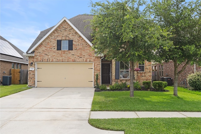 13610 Spectacled Bear Ln, Crosby, TX 77532 - view of front facade with brick siding, central air condition unit, a shingled roof, driveway, and a garage