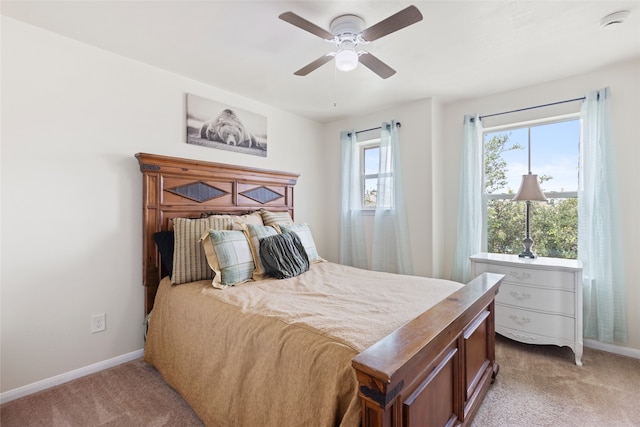 13610 Spectacled Bear Ln, Crosby, TX 77532 - bedroom with light carpet, baseboards, and a ceiling fan