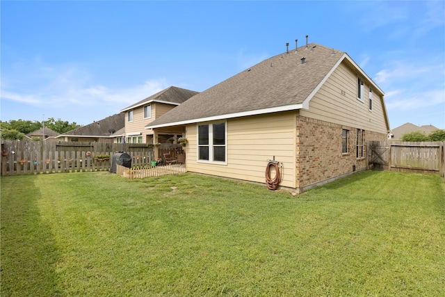 13610 Spectacled Bear Ln, Crosby, TX 77532 - back of house featuring brick siding and roof with shingles