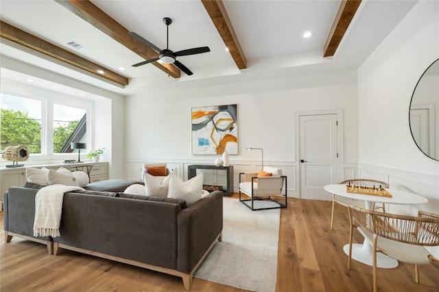 1611 Richelieu Ln, Houston, TX 77018 - living area with beamed ceiling, ceiling fan, light wood finished floors, wainscoting, and a decorative wall