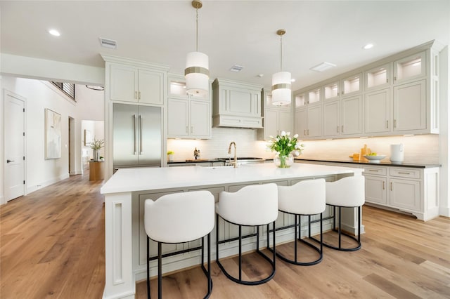 1611 Richelieu Ln, Houston, TX 77018 - kitchen with stainless steel built in fridge, custom exhaust hood, tasteful backsplash, a kitchen bar, and recessed lighting