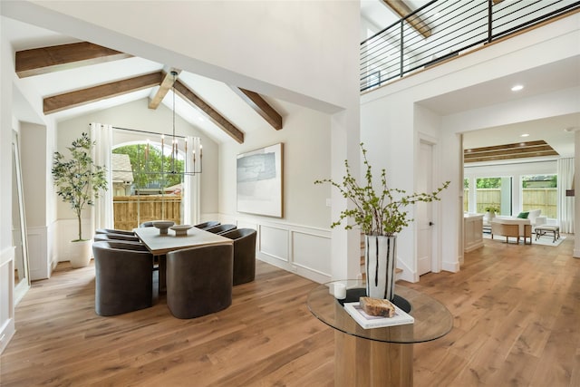 1611 Richelieu Ln, Houston, TX 77018 - dining space with beamed ceiling, healthy amount of natural light, a decorative wall, light wood-style floors, and wainscoting