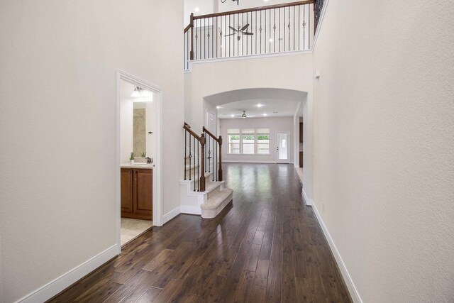 19903 Mulberry Pine Ln, Cypress, TX 77429 - foyer featuring stairway, dark wood-style flooring, a ceiling fan, baseboards, and a high ceiling