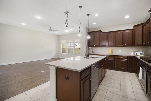 19903 Mulberry Pine Ln, Cypress, TX 77429 - kitchen featuring a sink, a ceiling fan, light tile patterned floors, stainless steel appliances, and decorative backsplash