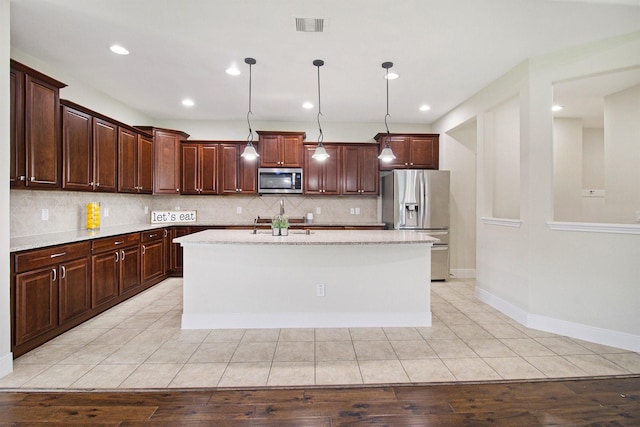 19903 Mulberry Pine Ln, Cypress, TX 77429 - kitchen featuring stainless steel appliances, tasteful backsplash, a center island with sink, decorative light fixtures, and recessed lighting