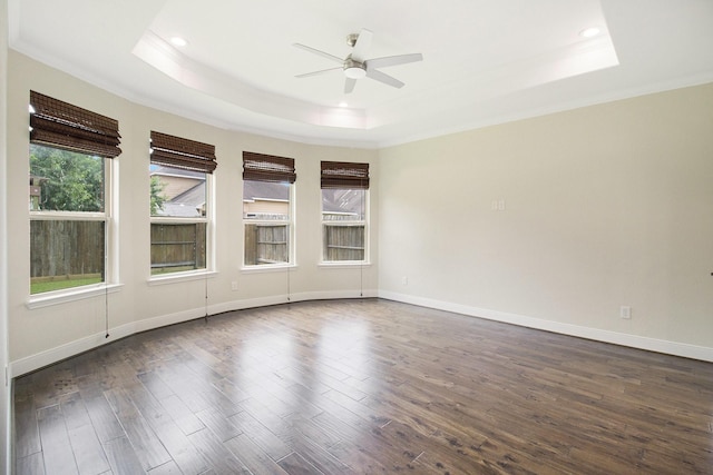 19903 Mulberry Pine Ln, Cypress, TX 77429 - spare room featuring a tray ceiling, crown molding, ceiling fan, dark wood-style flooring, and baseboards