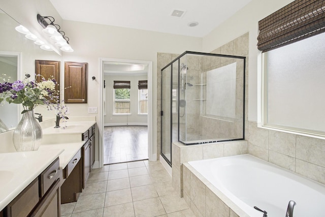 19903 Mulberry Pine Ln, Cypress, TX 77429 - full bathroom featuring vanity, a garden tub, a shower stall, and tile patterned flooring