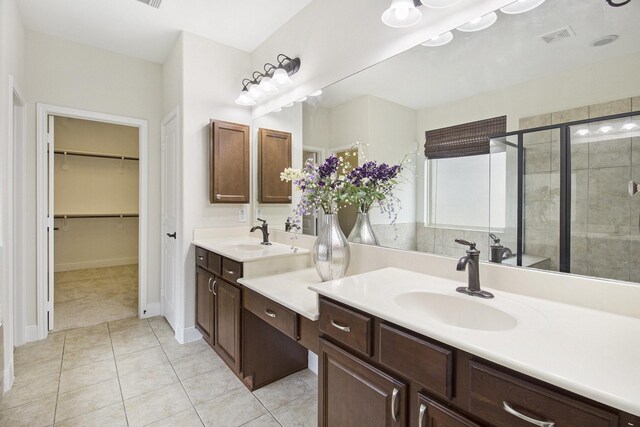 19903 Mulberry Pine Ln, Cypress, TX 77429 - bathroom featuring double vanity, a shower stall, a spacious closet, tile patterned flooring, and baseboards