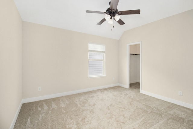 19903 Mulberry Pine Ln, Cypress, TX 77429 - unfurnished bedroom with light carpet, baseboards, a spacious closet, and vaulted ceiling