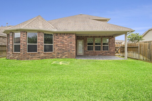 19903 Mulberry Pine Ln, Cypress, TX 77429 - back of house featuring roof with shingles, a patio area, and brick siding