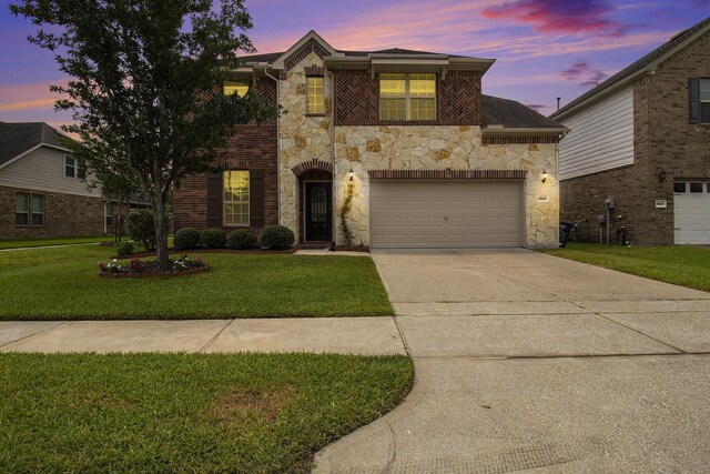 19903 Mulberry Pine Ln, Cypress, TX 77429 - view of front of home featuring stone siding, driveway, a yard, and an attached garage