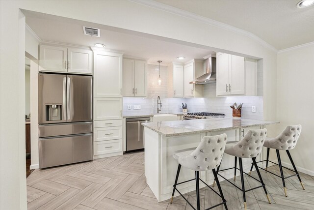 1709 Chantilly Ln, Houston, TX 77018 - kitchen featuring stainless steel appliances, wall chimney range hood, a sink, a peninsula, and white cabinetry