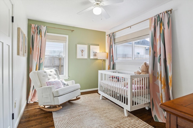 1709 Chantilly Ln, Houston, TX 77018 - bedroom featuring wood finished floors, baseboards, a crib, and a ceiling fan