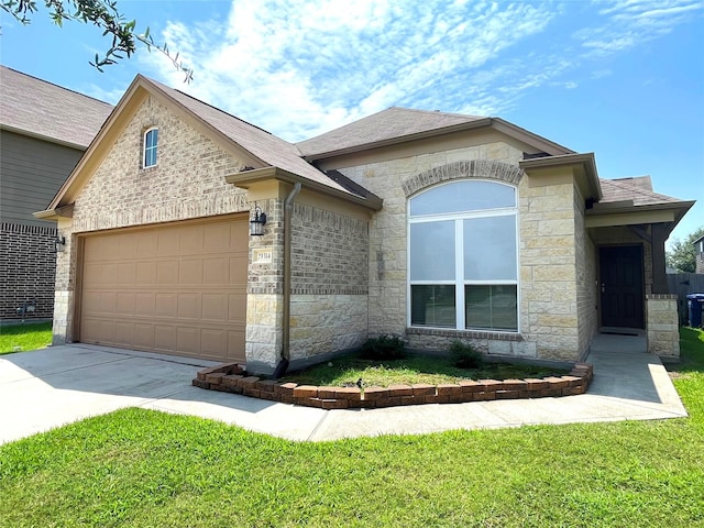 29314 Nectar Bloom Ct, Spring, TX 77386 - view of front of home featuring stone siding, an attached garage, driveway, and a front lawn