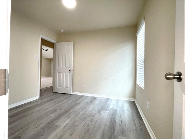 29314 Nectar Bloom Ct, Spring, TX 77386 - unfurnished bedroom featuring wood finished floors, multiple windows, and baseboards