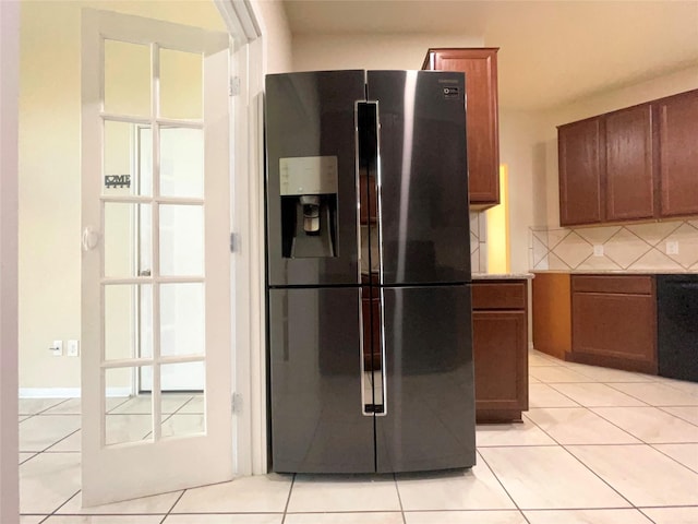 29314 Nectar Bloom Ct, Spring, TX 77386 - kitchen with stainless steel fridge with ice dispenser, decorative backsplash, light tile patterned floors, brown cabinetry, and black dishwasher