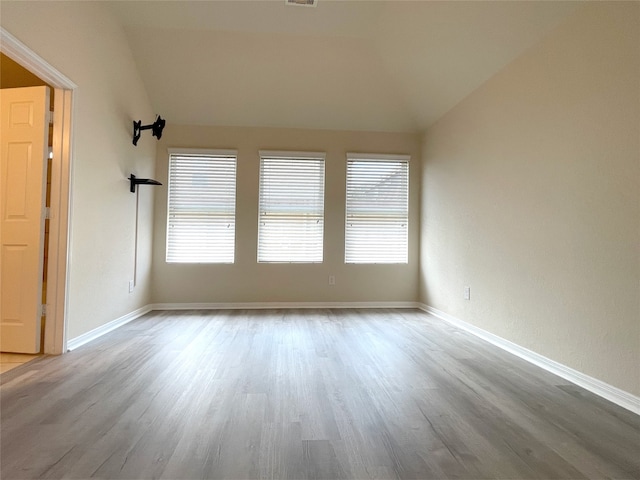 29314 Nectar Bloom Ct, Spring, TX 77386 - spare room featuring lofted ceiling, wood finished floors, healthy amount of natural light, and baseboards