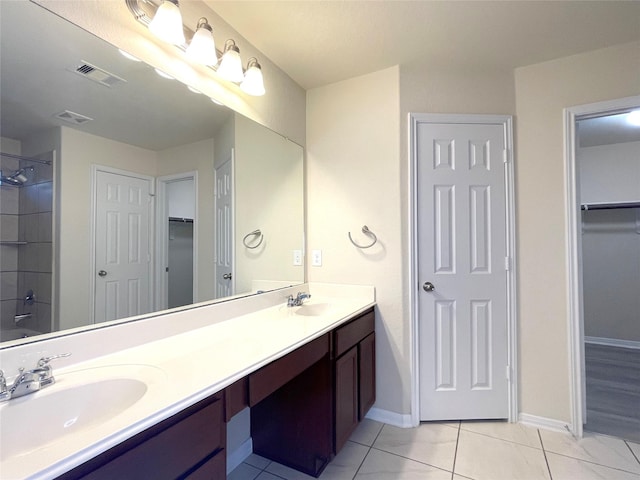 29314 Nectar Bloom Ct, Spring, TX 77386 - bathroom with double vanity, tile patterned flooring, a walk in closet, and baseboards