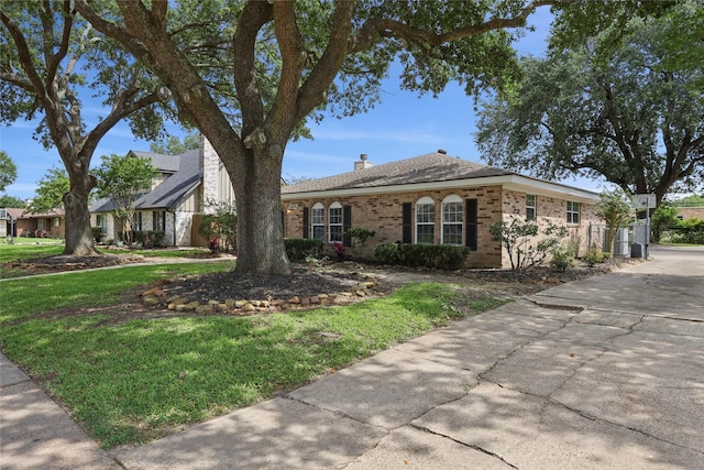 1008 N 30th St, Nederland, TX 77627 - single story home featuring brick siding, a chimney, a front lawn, concrete driveway, and a shingled roof