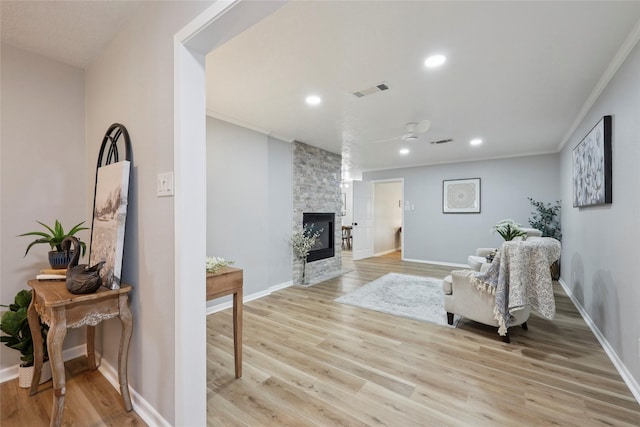 1008 N 30th St, Nederland, TX 77627 - living area featuring light wood finished floors, recessed lighting, a fireplace, crown molding, and baseboards