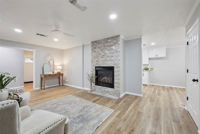 1008 N 30th St, Nederland, TX 77627 - living room with crown molding, light wood-style flooring, ceiling fan, a fireplace, and recessed lighting
