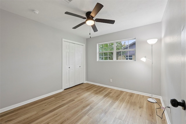 1008 N 30th St, Nederland, TX 77627 - unfurnished bedroom with baseboards, light wood-style floors, a closet, and a ceiling fan