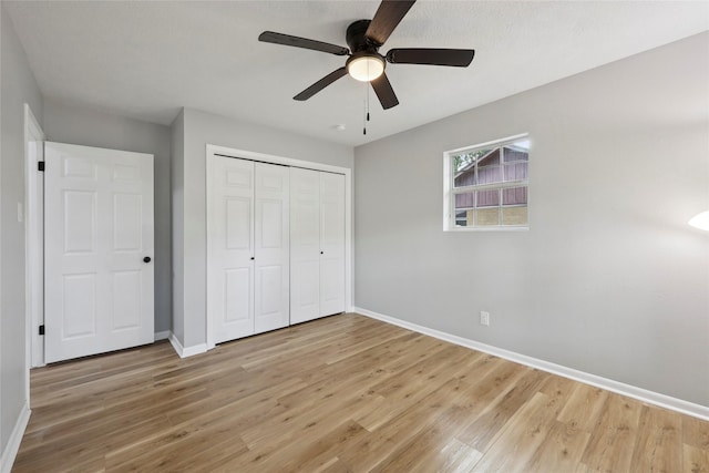 1008 N 30th St, Nederland, TX 77627 - unfurnished bedroom with baseboards, light wood-style flooring, a closet, and a ceiling fan