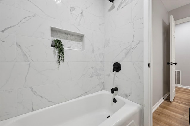 1008 N 30th St, Nederland, TX 77627 - full bath featuring wood finished floors,  shower combination, and baseboards
