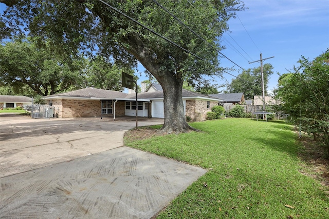1008 N 30th St, Nederland, TX 77627 - view of front of house with a trampoline, driveway, an attached garage, and brick siding