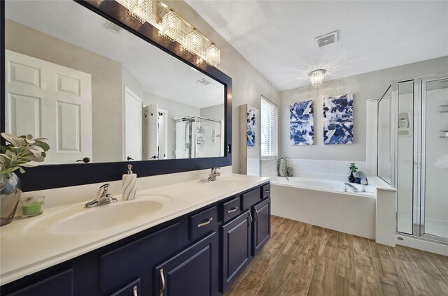 15314 Yellow Oak Trl, Cypress, TX 77433 - bathroom with a shower stall, a garden tub, wood finished floors, and double vanity