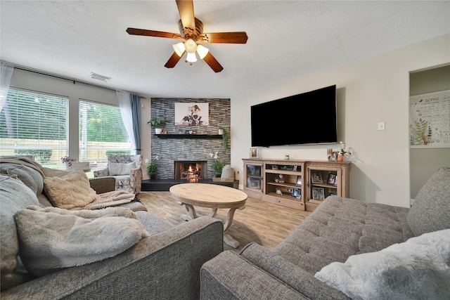 15314 Yellow Oak Trl, Cypress, TX 77433 - living area featuring a ceiling fan, wood finished floors, and a fireplace