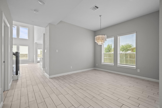 2302 Elmwood Trl, Katy, TX 77493 - spare room with a chandelier, baseboards, and light wood-style flooring