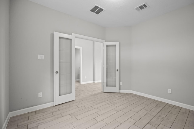 2302 Elmwood Trl, Katy, TX 77493 - unfurnished room featuring french doors, wood finished floors, and baseboards
