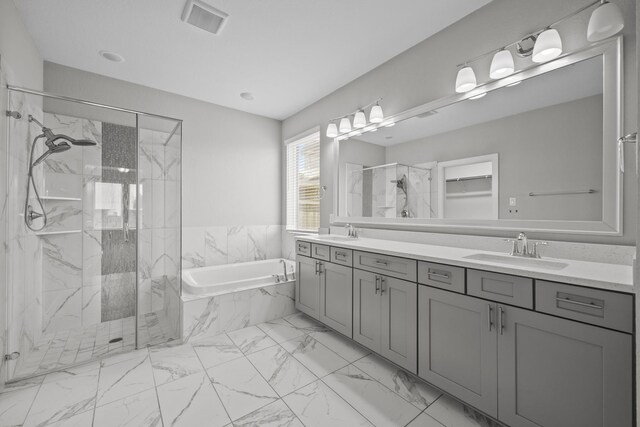 2302 Elmwood Trl, Katy, TX 77493 - full bathroom featuring a garden tub, double vanity, a marble finish shower, and marble look tiles