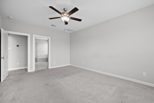 2302 Elmwood Trl, Katy, TX 77493 - unfurnished bedroom featuring carpet floors, baseboards, a ceiling fan, and ensuite bathroom