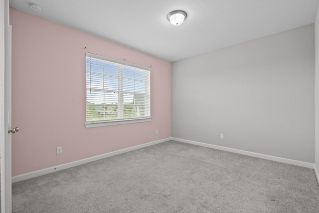 2302 Elmwood Trl, Katy, TX 77493 - empty room featuring a smoke detector, carpet, and baseboards