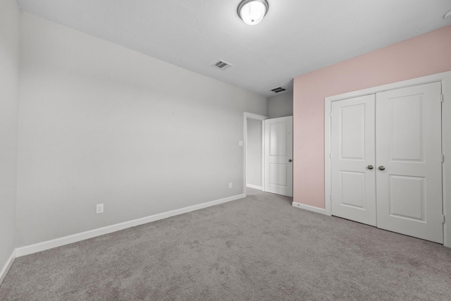 2302 Elmwood Trl, Katy, TX 77493 - unfurnished bedroom with carpet flooring, baseboards, and a closet