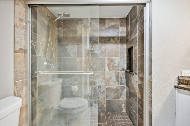3525 Sage Rd Unit 1713, Houston, TX 77056 - bathroom featuring toilet and a shower stall