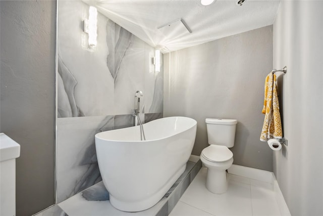 3525 Sage Rd Unit 1713, Houston, TX 77056 - full bathroom with a freestanding bath, tile patterned flooring, toilet, and baseboards