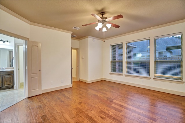 10 Tallgrass Way, Spring, TX 77389 - spare room with crown molding, light wood-type flooring, a ceiling fan, and a textured ceiling