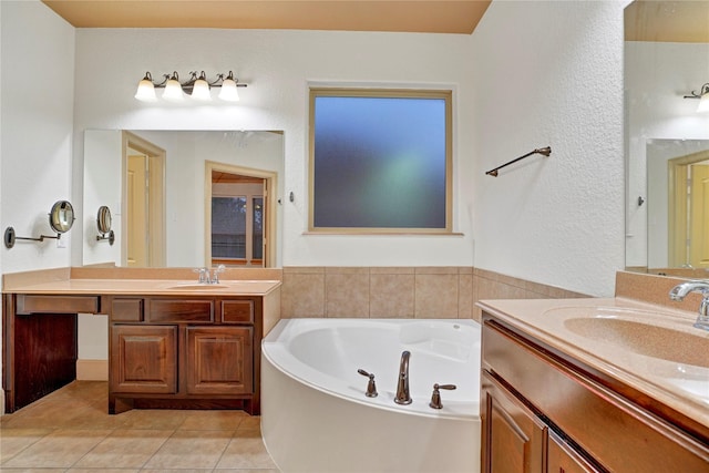 10 Tallgrass Way, Spring, TX 77389 - bathroom featuring two vanities, a bath, tile patterned flooring, and a textured wall