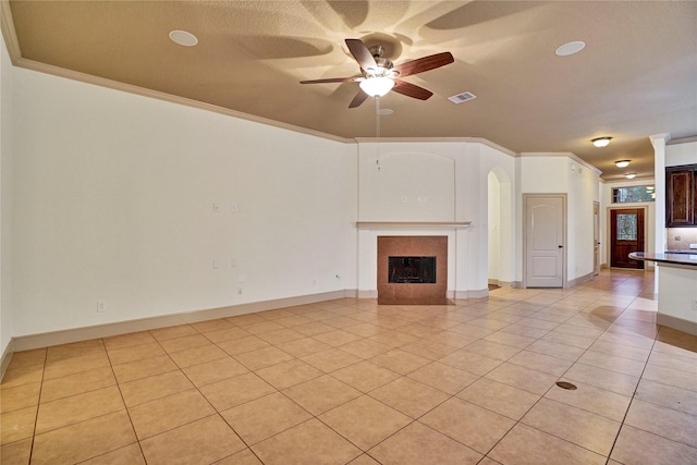 10 Tallgrass Way, Spring, TX 77389 - unfurnished living room featuring a ceiling fan, light tile patterned floors, ornamental molding, and a tile fireplace