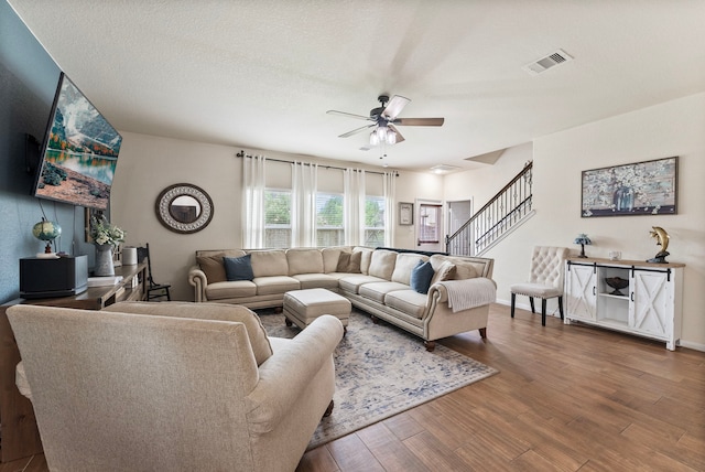 14706 Meadow Acre Trl, Houston, TX 77049 - living room featuring ceiling fan, wood finished floors, and stairs