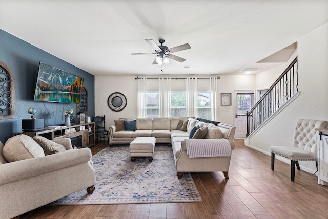 14706 Meadow Acre Trl, Houston, TX 77049 - living room with wood finished floors, a ceiling fan, stairs, and baseboards