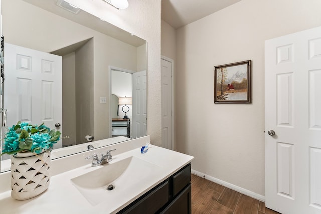 14706 Meadow Acre Trl, Houston, TX 77049 - bathroom with wood finished floors, vanity, and baseboards