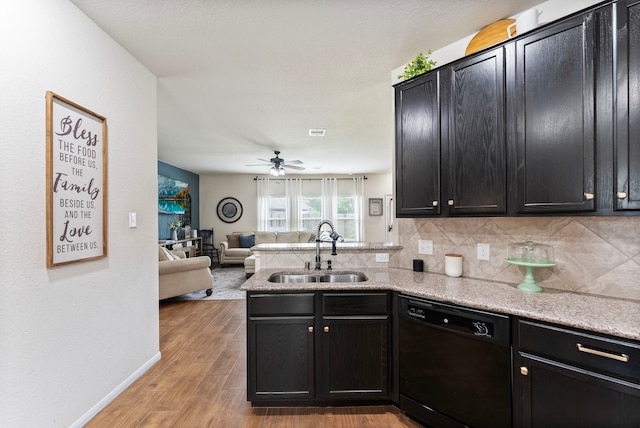 14706 Meadow Acre Trl, Houston, TX 77049 - kitchen with dishwasher, a sink, dark cabinetry, and tasteful backsplash